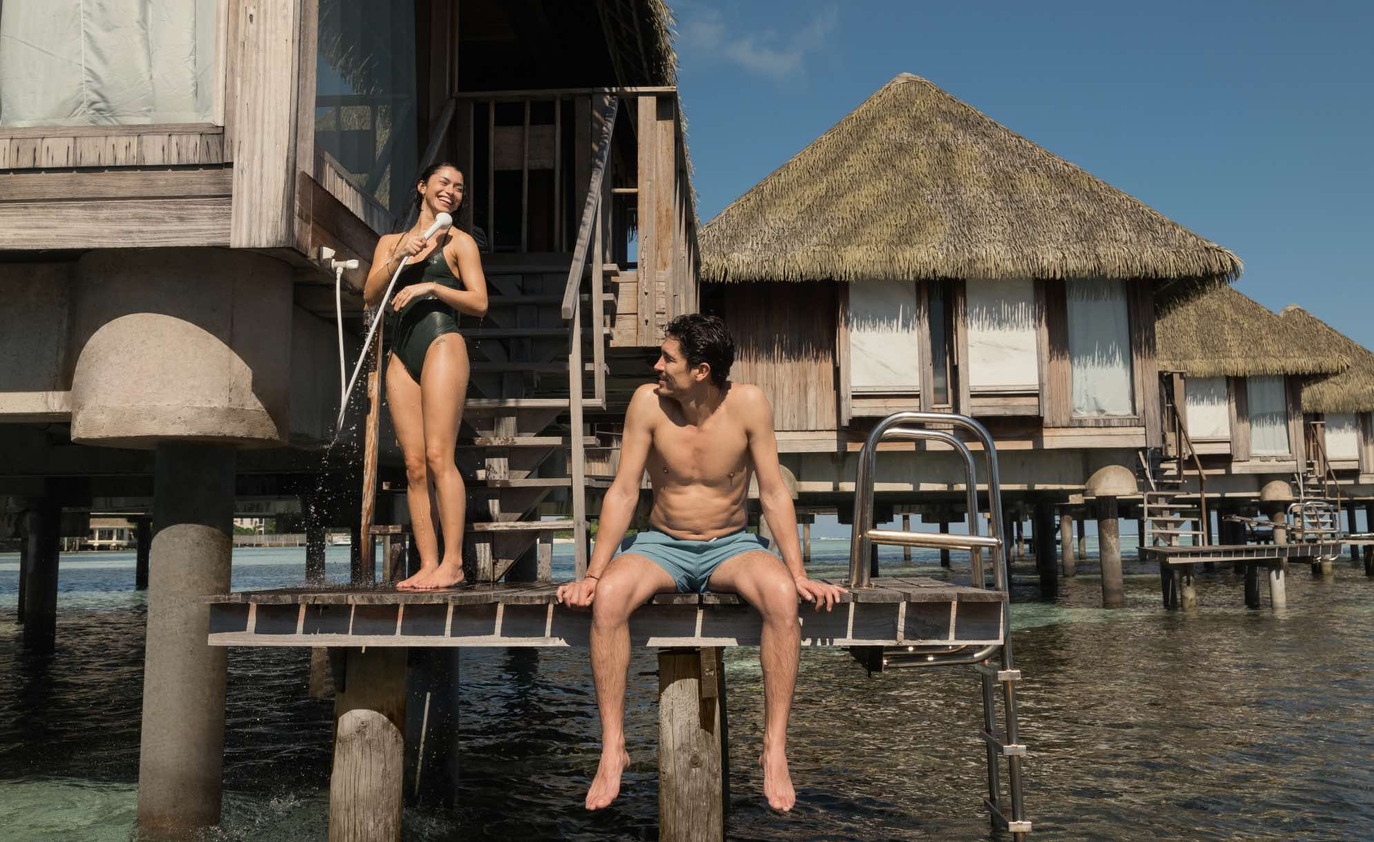 a man and a woman conversing at a Club Med kani suite