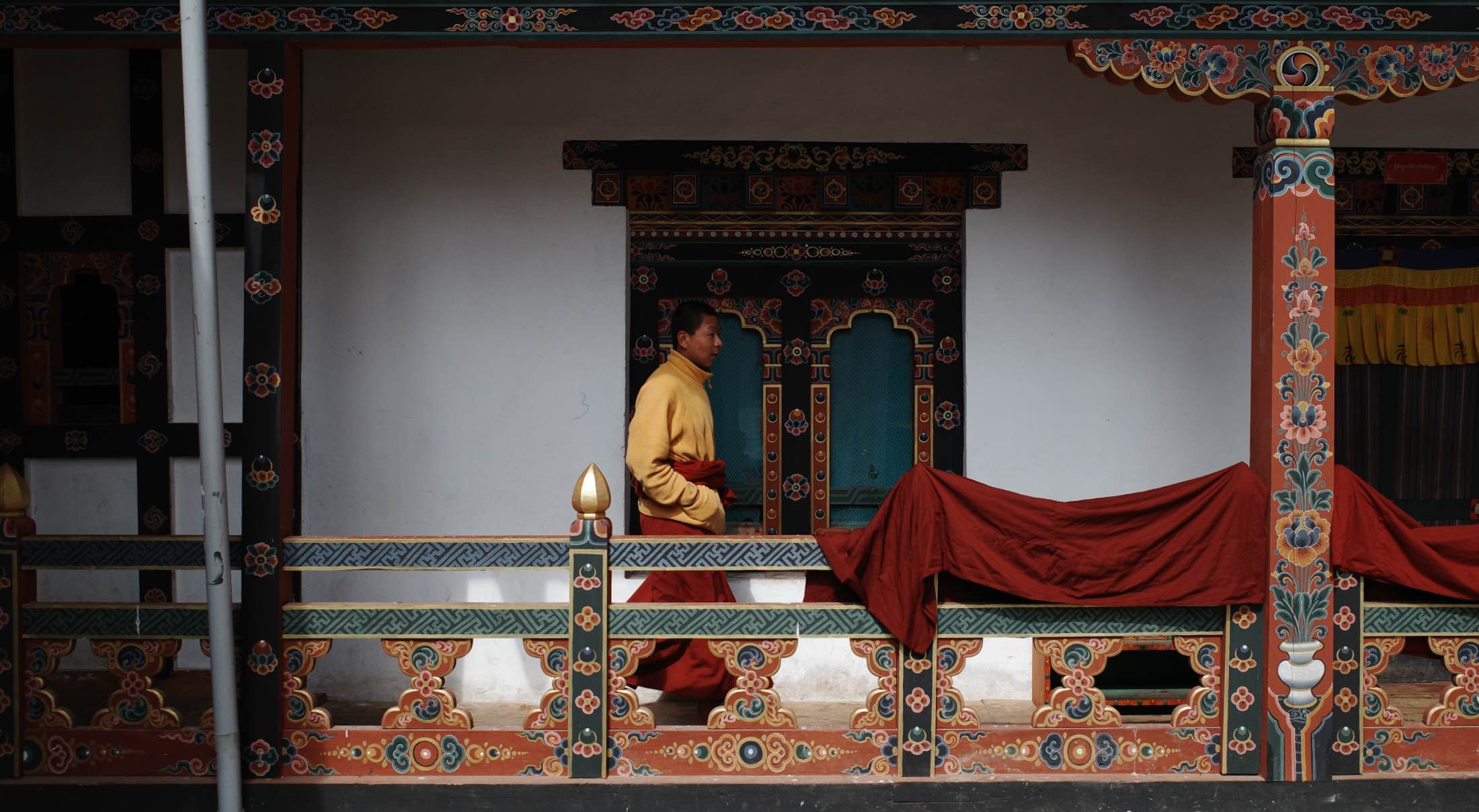 a monk in a walking through a monastery in Bhutan