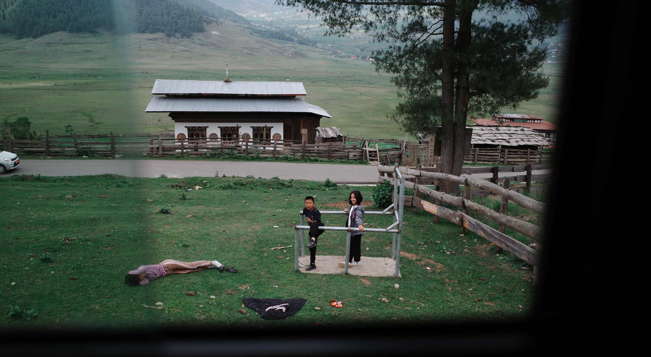 a group of kids playing in a field in Bhutan