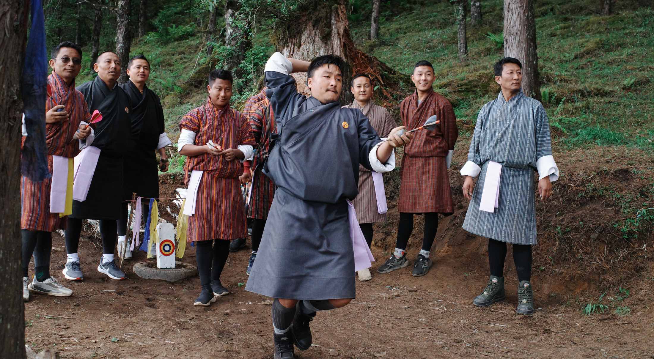 a group of bhutanese men playing darts