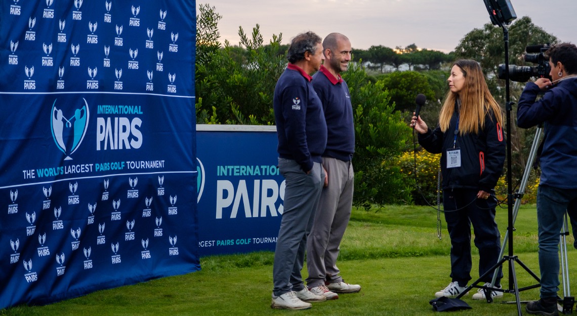 two golfers being interviewed on the green