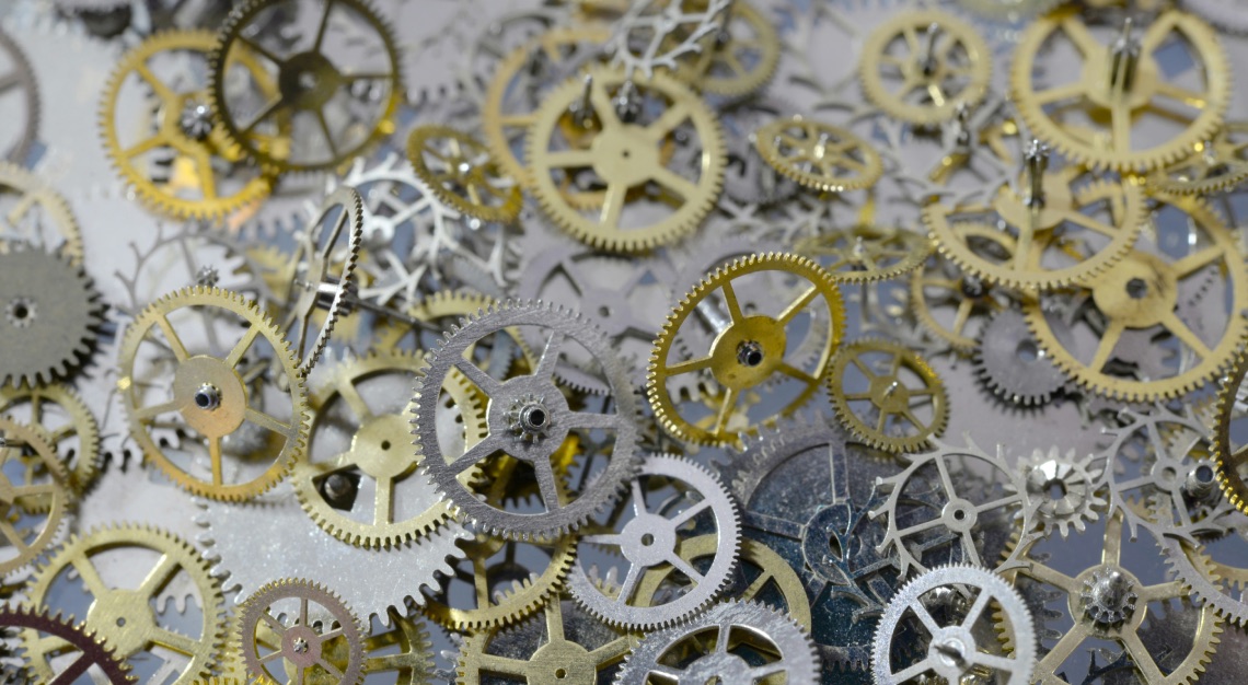 cogs and gears being thrown onto a table