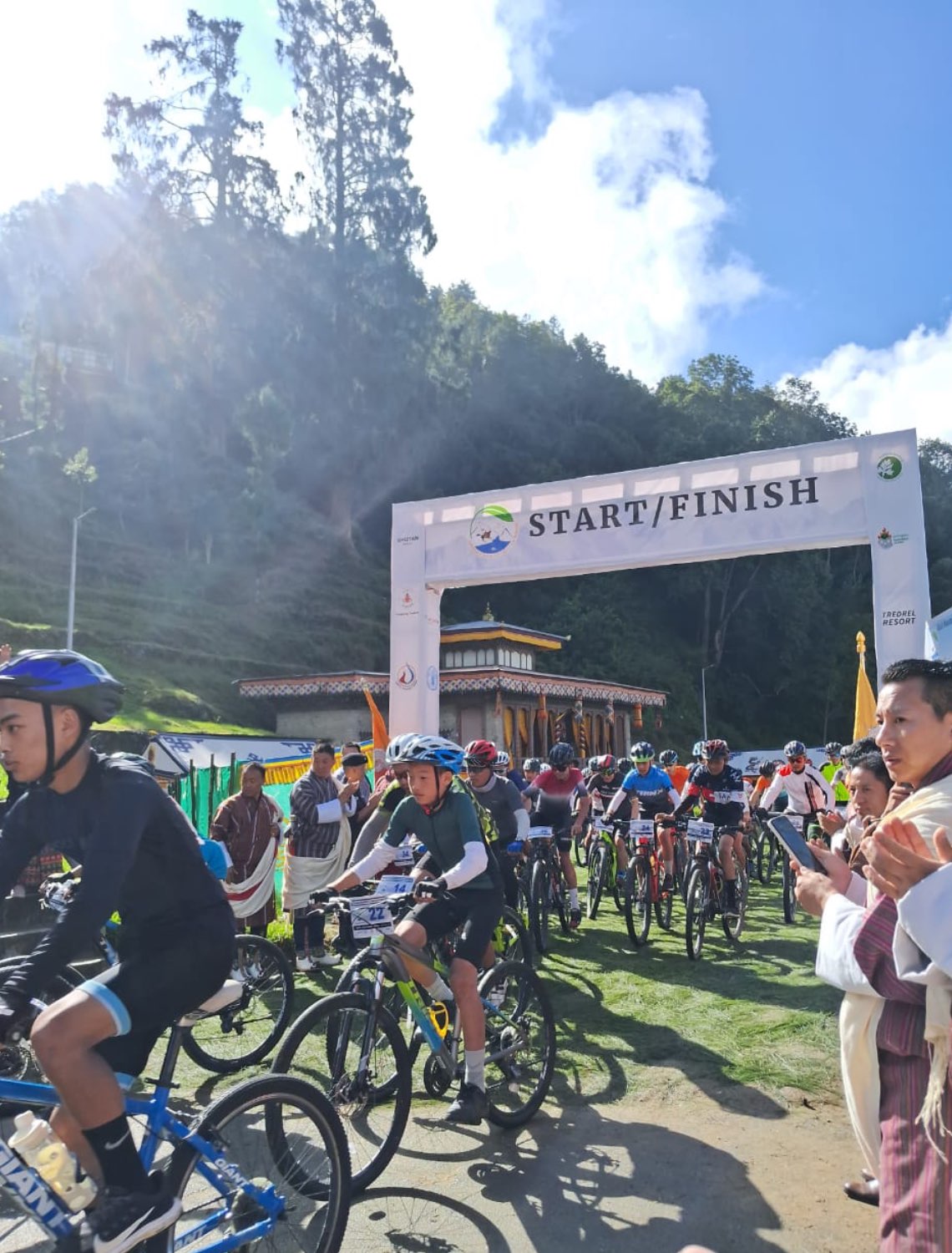 bhutanese racing on bicycles at a festival