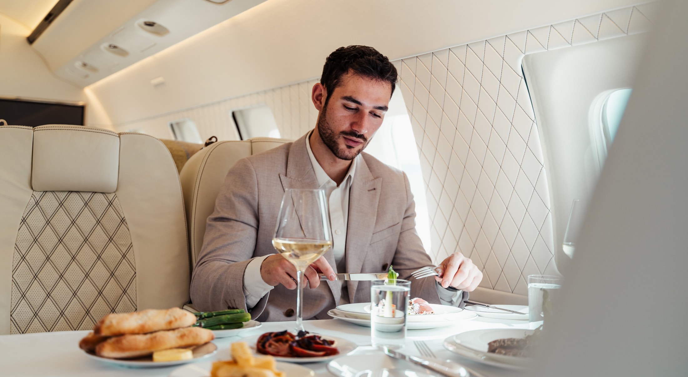 a man enjoying a meal on a private jet