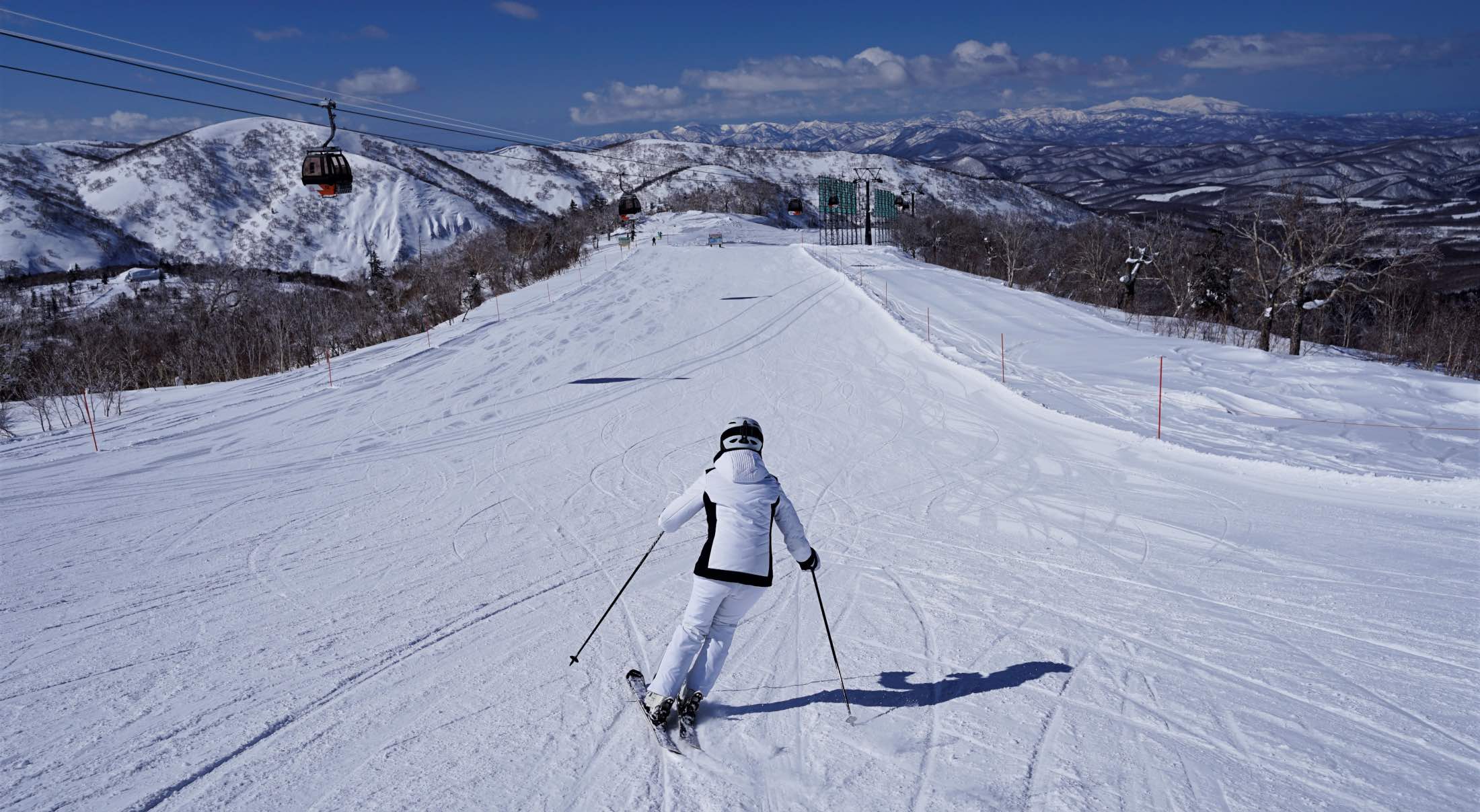 a person skiing down a Japanese slope