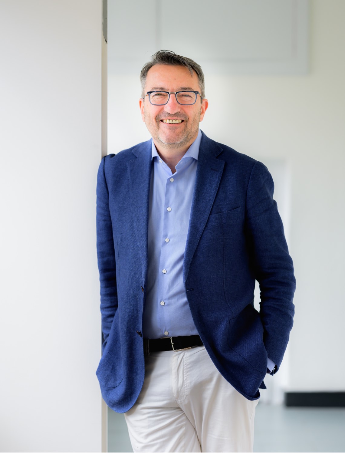 A man in a suit smiling